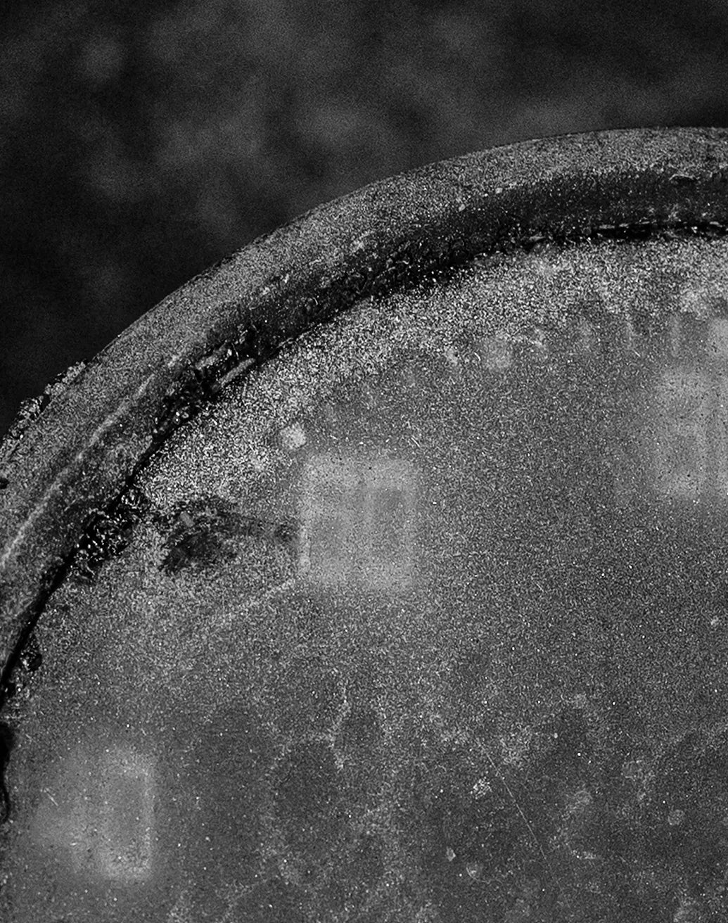 Black-and-white close-up of an original Land Rover instrument with weathered glass