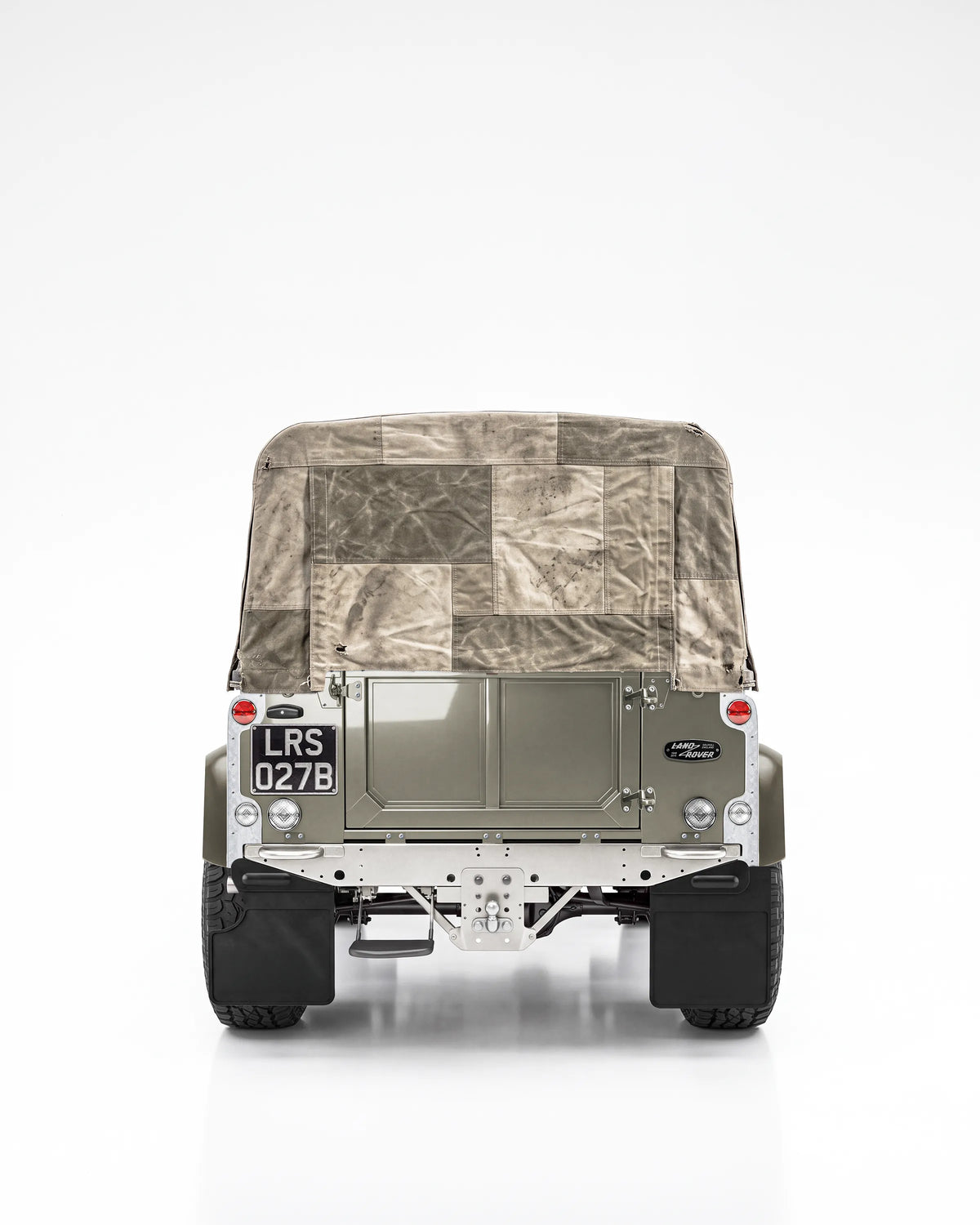 Rear view of the Arden Green Defender 90 with a handmade waxed patchwork soft top