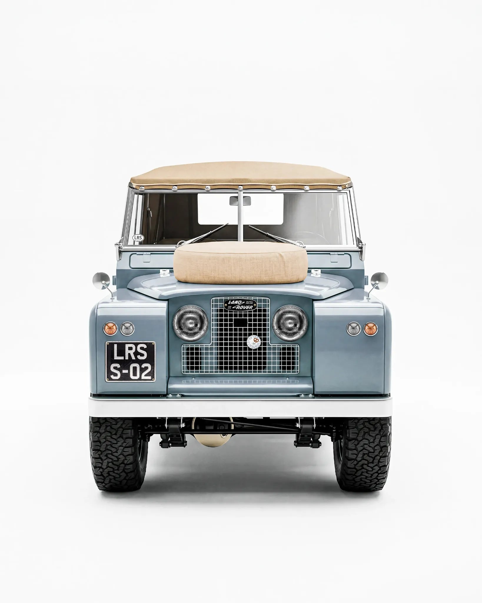 A blue Series Land Rover with tan canvas roof